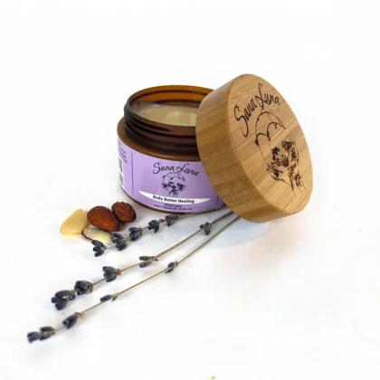 A jar of lavender and shea butter with some sticks