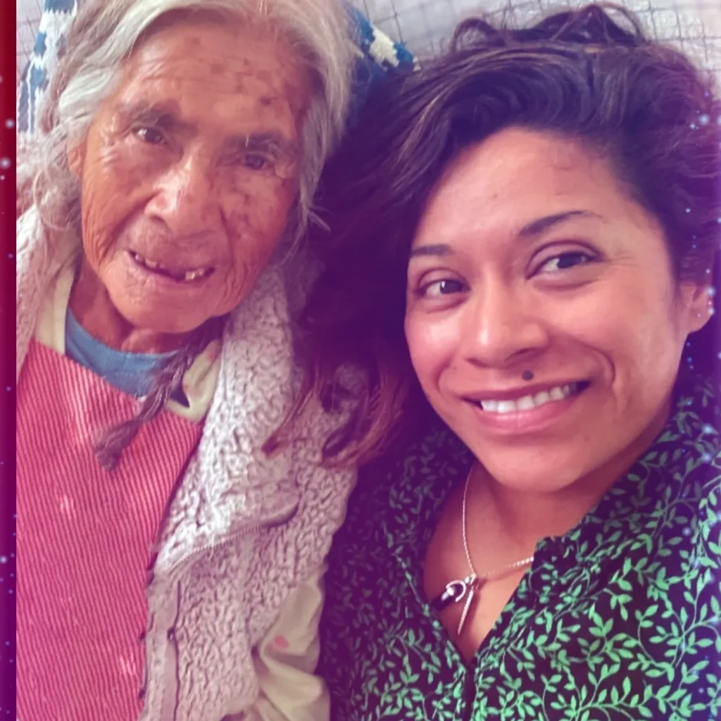 A woman and an old lady smiling for the camera.